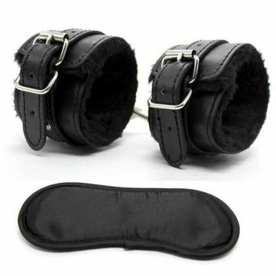 Leather handcuffs with fur lining and blindfold from BDSM bondage couples kit close-up view