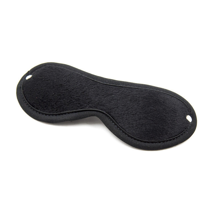 Black leather blindfold eye mask from BDSM bondage kit for couples sensory play