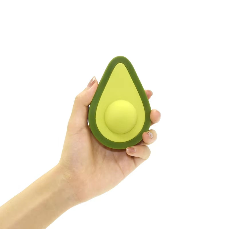 Hand holding avocado clitoral vibrator button-controlled showing compact size for women